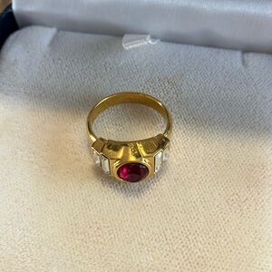 Beautiful gold ring with center ruby/ diamond chips 
Costume but look real